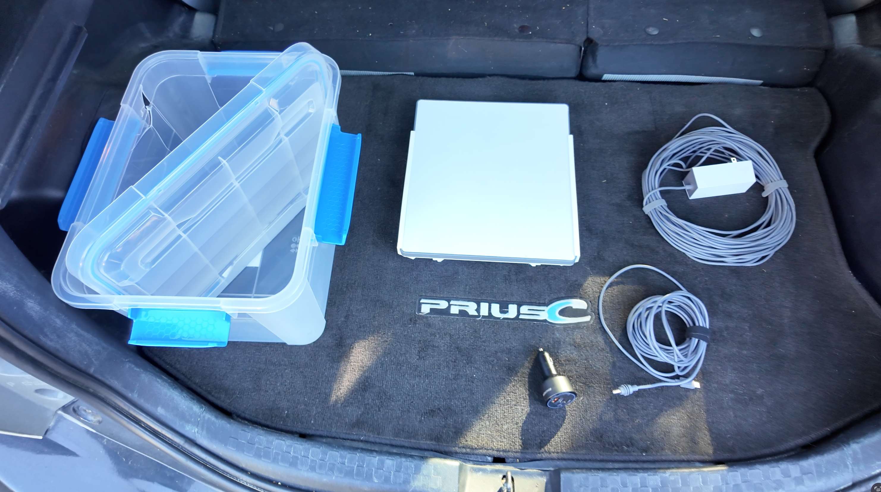 Starlink rental kit contents including carrying case, Starlink Mini dish, power cables, and 12V adapter